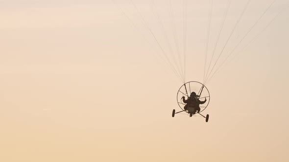 Tandem Paramotor Gliding - Two Men Flying and Gliding in the Air