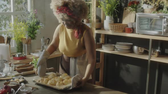 Woman Holding Freshly Baked Pastries and Speaking on Camera