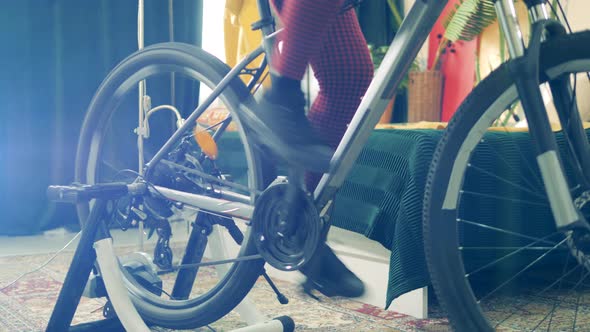 One Girl Spins the Pedals During Workout, Staying Home.