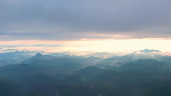 4K Flying through the clouds above mountain tops