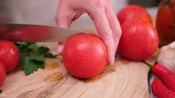 Woman Making Cuts for Tomato Blanching