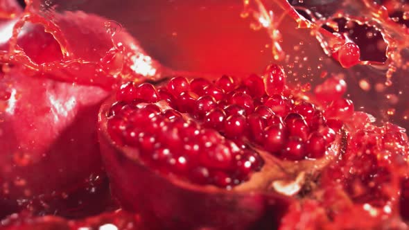 Slow Motion Shot of Pomegranate Juice Splashing Through Pomegranate
