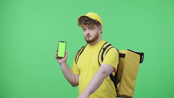 Portrait of Young Men Holding Phone with Green Screen Showing Thumbs Up