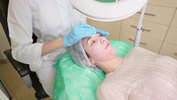 Beautician Preparing Woman Face Before Skincare Beauty Procedure in Clinic