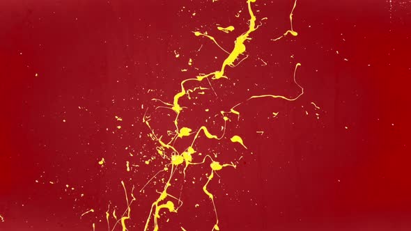 Splashes of Yellow Color Paint on the Red Wall