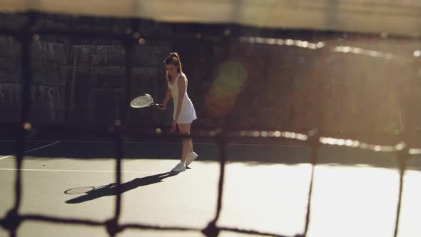 Woman playing tennis on a sunny day