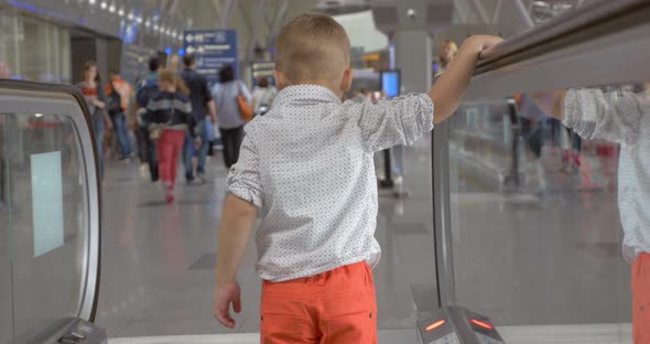 Little Boy Coming Off the Escalator