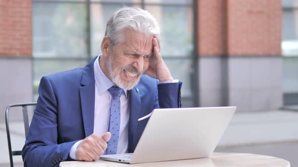 Upset Old Businessman Reacting to Loss on Laptop Outdoor