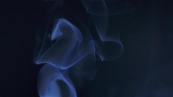 Abstract Smoke Cloud. Blue Smoke Slowly Floating Through Space Against Black Background. Close Up