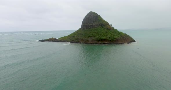 Extreme wide aerial shot of a small island off the coast of Hawaii