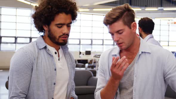 Two male business executives interacting with each other