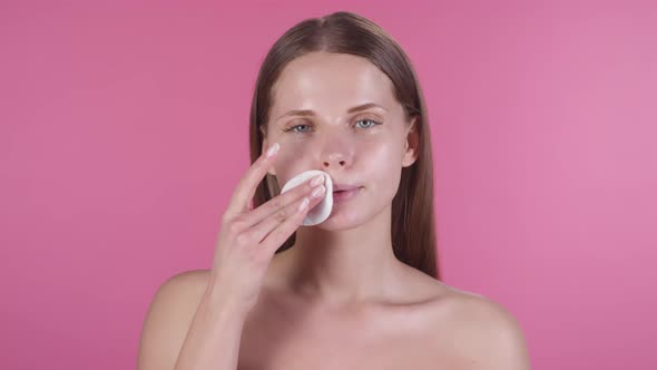 Portrait of Woman Wiping Face with Cotton Pad