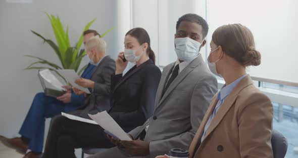 Diverse Business People Waiting for Job Interview with Face Mask