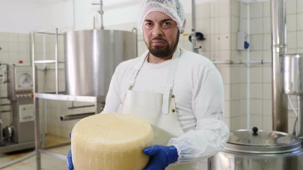 Cheese maker showing great cheese shape- Diary Cheese factory