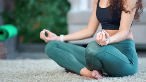 Silhouette of Young Athletic Female Body Practicing Yoga Sitting in Lotus Pose Tilt Down Closeup