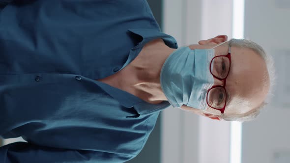 Vertical Video Portrait of Senior Patient Attending Medical Consultation in Cabinet