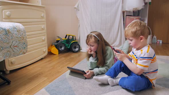 Boy And Girl With Phone And Tablet