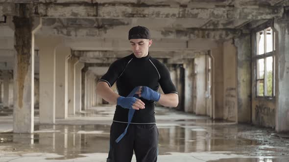 Boxer Wrapping Hands Before Fighting. Young Athlete Getting Ready for Fight