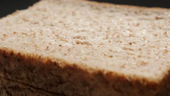 Toast bread baked of whole grain wheat close-up slow tilt 4K 2160p 30fps UltraHD footage - Shallow D