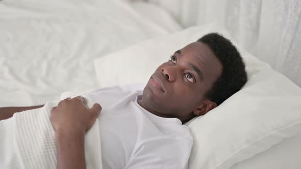 Worried African Man Awake in Bed 