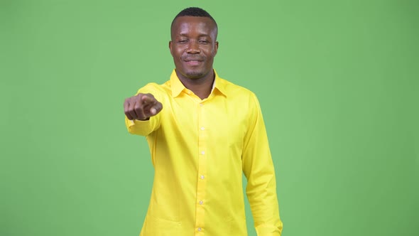 Young Happy African Businessman Pointing To Camera