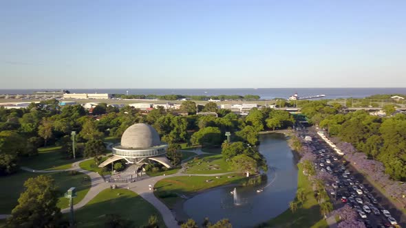 Aerial panning shot of Bosques de Palermo at golden hour, Buenos Aires