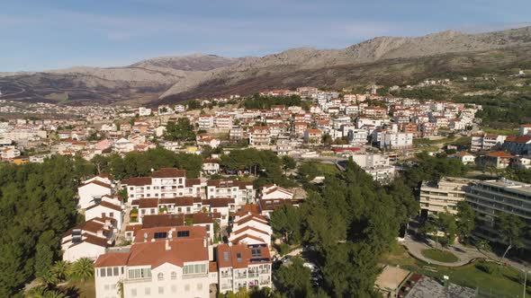 Hilly landscape and majestic buildings of Split town in Croatia, aerial fly forward shot