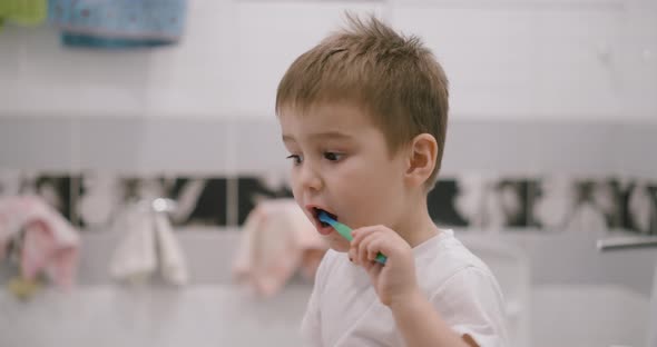 The Child Cleans His Teeth in Front of a Mirror