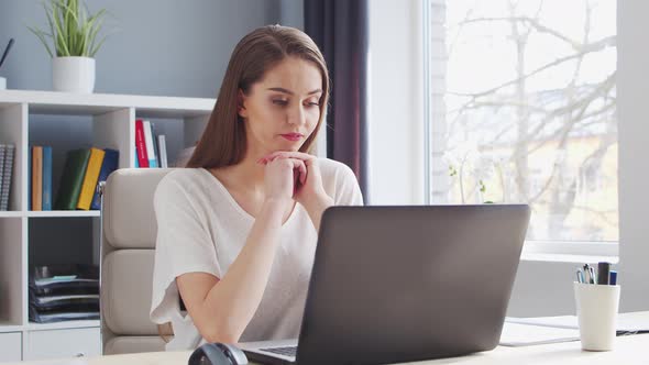 Young Woman Works at Home Office Using Computer.