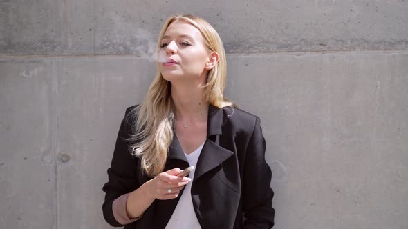 Stylish Woman Smoking on Street