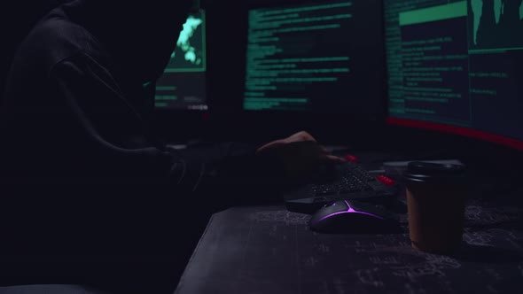 Man Hacker Hands Typing Data On A Keyboard, Seen On A Computer Monitor