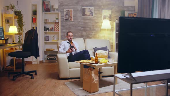 Young Businessman in Suit and Tie Relaxing Drinking Beer