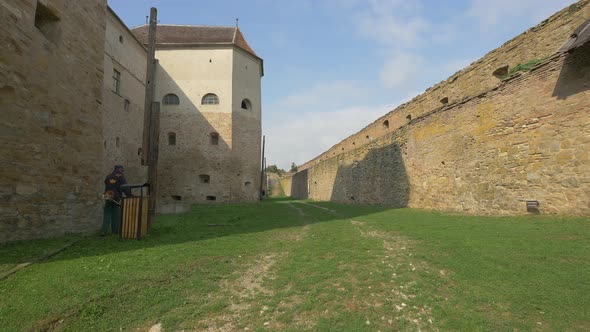 Cutting grass in a fortress courtyard