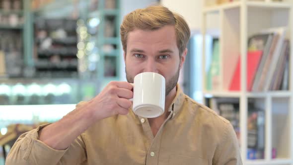 Portrait of Handsome Young Man Drinking Coffee