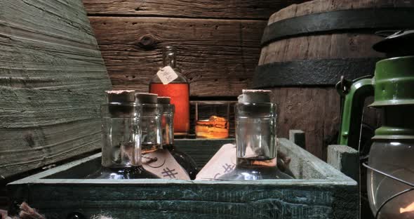 Golden whisky in glass and bottle in old distillery warehouse.