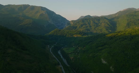 aerial view of sunrise in mountains with river in canyon