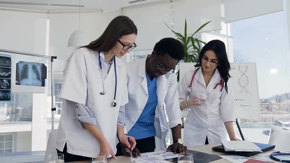 Team of Doctors Discussing Result of Blood Analysis