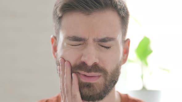 Face of Young Man Having Toothache Cavity