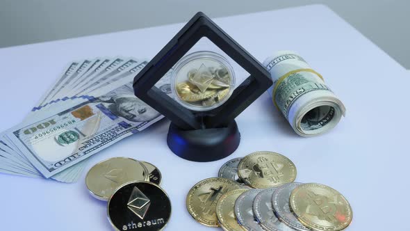Golden Bitcoin BTC and ethereum ETH coins rotating on bills of 100 dollars