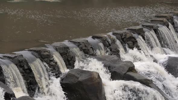 SLOW MOTION Rocky Manmade Weir With Powerful River Water Flowing Over