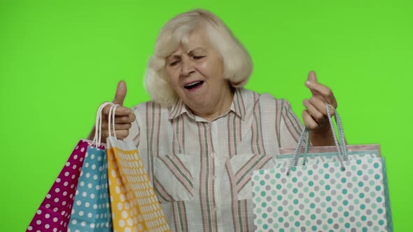 Grandmother Holding Shopping Bags, Rejoicing Discounts in Store, Enjoying Shopping with Low Prices