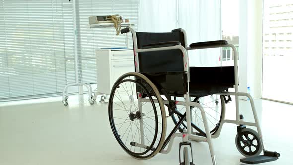 Black wheelchair in medical bedroom