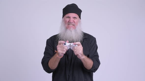 Stressed Mature Bearded Hipster Man Playing Games and Losing