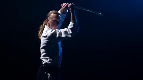 Man Fighting at Aikido Training with Japanese Sword Katana in Martial Arts School. Healthy Lifestyle