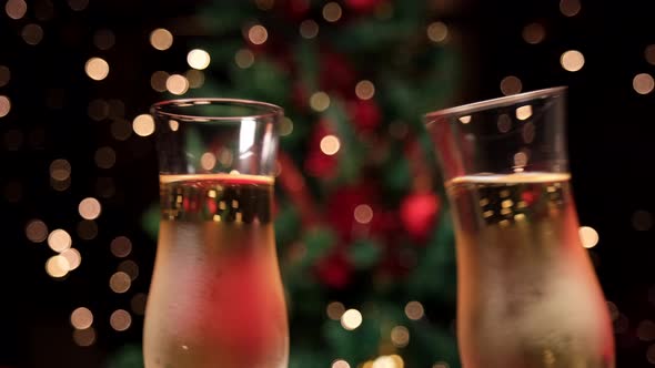 Champagne toast for Christmas celebration. Two sparkling white wine toasting drink in party.