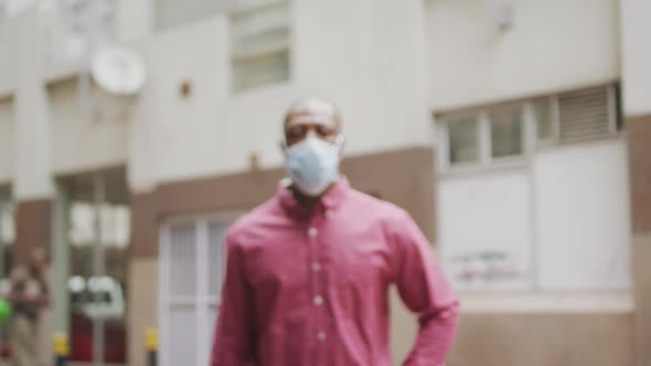 African american man on the go wearing coronavirus covid19 mask