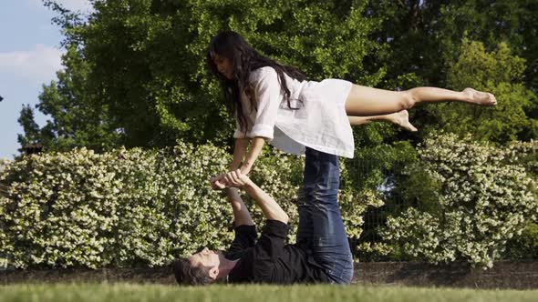 Modern dancers practicing front bird in summer garden