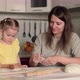 Mom Kisses Her Daughter While Baking Pastry - VideoHive Item for Sale