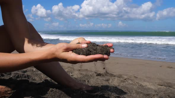 Closeup of Hands Releasing Sand