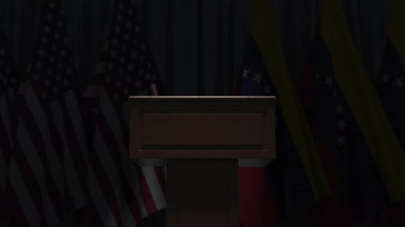 Many Flags of Venezuela and the USA Behind Speaker Tribune